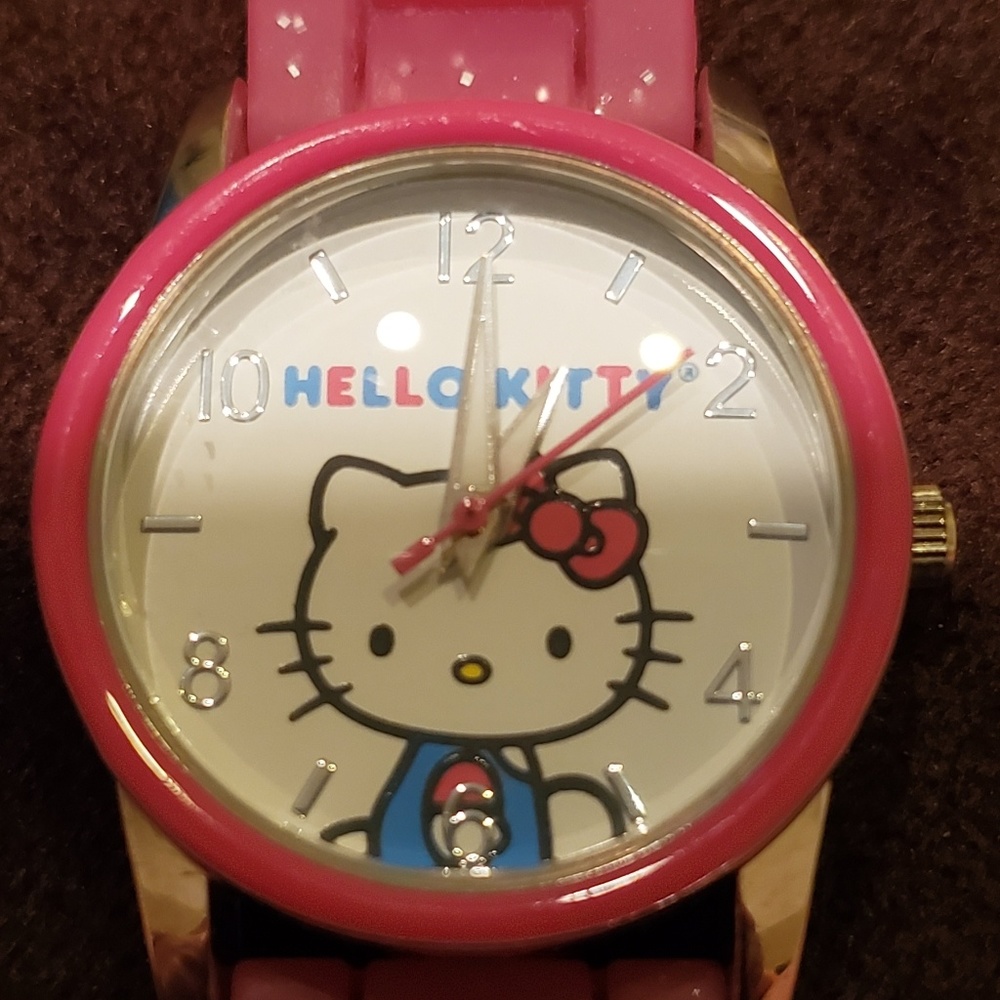Sanrio Hello Kitty pink watch with white face.